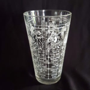 Vintage shaker glass with cocktail recipes